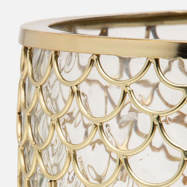 Close-up of Gila brush holder's gold scalloped metal overlay and clear glass body.