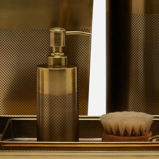 Gold-toned Hagen brush holder styled with soap dispenser on mirrored tray.