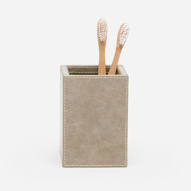 Pigeon & Poodle Hampton brush holder in taupe suede with contrast stitching, holding two bamboo toothbrushes.