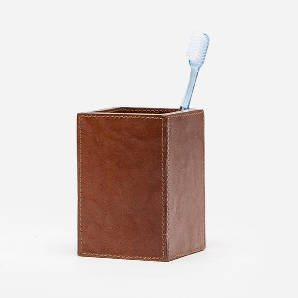 Tan leather Hampton brush holder with contrast stitching, shown with toothbrush.