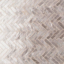 Close-up of ivory herringbone mother-of-pearl mosaic surface texture.
