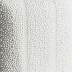 Close-up of Pigeon & Poodle Hilo bath canister showing raised dot texture in white.