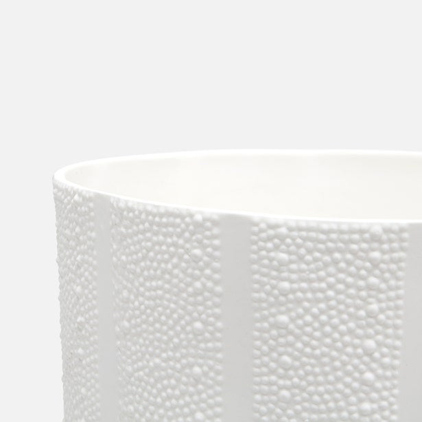 Close-up of Pigeon & Poodle Hilo bath canister rim, white textured dot relief surface.