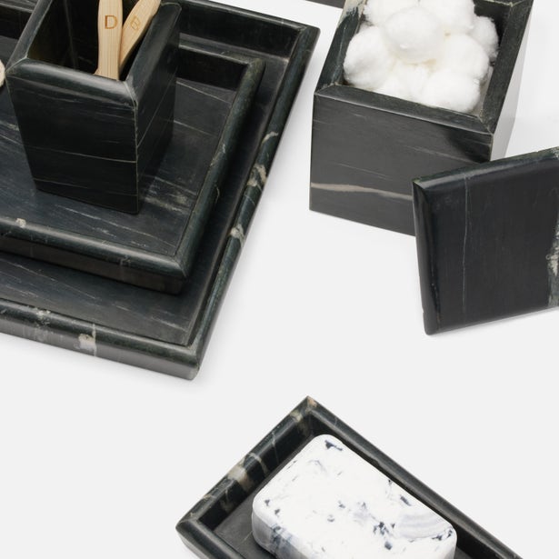 Black and white marble Kavala bathroom accessories set styled with cotton balls and a soap bar.