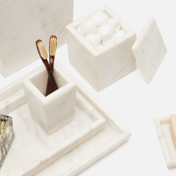 White marble Kavala bath canister with lid ajar, styled alongside matching tray and toothbrush holder.