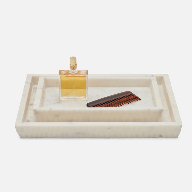 Pigeon & Poodle Kuna marble nesting tray set styled with perfume bottle and comb.