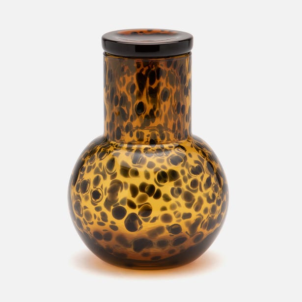 Lausanne carafe close-up showing amber tortoiseshell glass pattern with dark spots.
