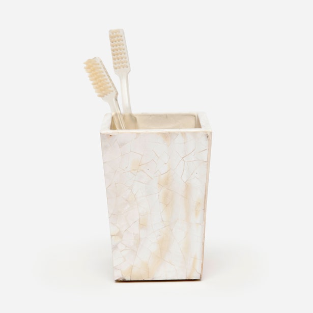 Pigeon & Poodle Lugano brush holder in ivory capiz shell, styled with toothbrushes.
