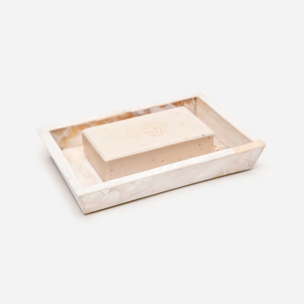 Pigeon & Poodle Lugano soap dish in cream marble with embossed bar soap, angled view.