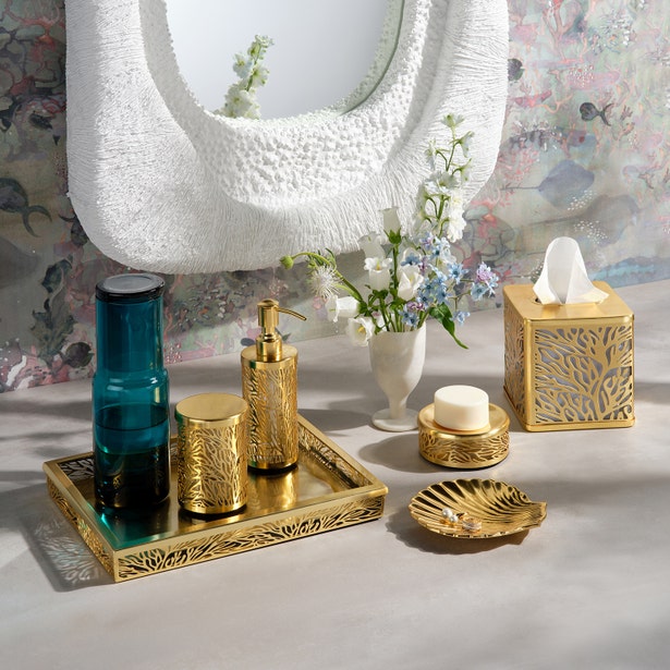 Pigeon & Poodle Lynn gold soap pump styled with matching bathroom accessories on a vanity tray.