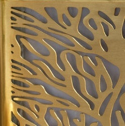 Gold soap pump with intricate cutout leaf pattern detail.