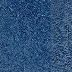 Close-up of cobalt blue textured ceramic surface with pebbled pattern.