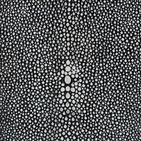 Close-up of black stingray-embossed texture with white dot pattern on bath canister.