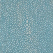 Close-up of turquoise fabric with tone-on-tone scattered dot pattern.