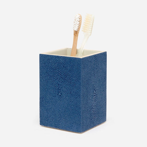 Navy blue shagreen-textured brush holder with two toothbrushes, ivory interior lining.