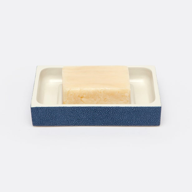 Navy blue shagreen-textured soap dish holding a bar of soap, ivory resin interior.