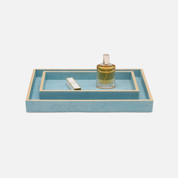 Teal shagreen-texture nesting trays with gold trim, styled with perfume bottle and lighter.