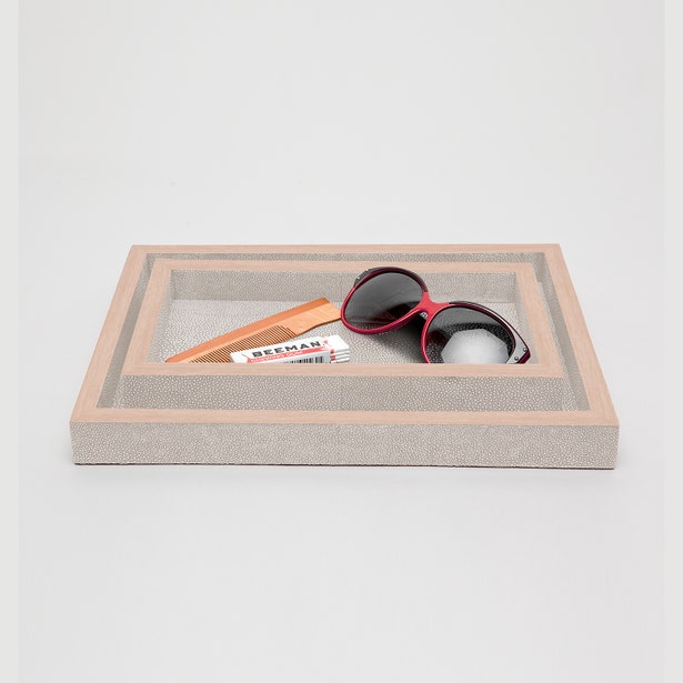 Grey shagreen-texture tray styled with sunglasses and small accessories, angled view.