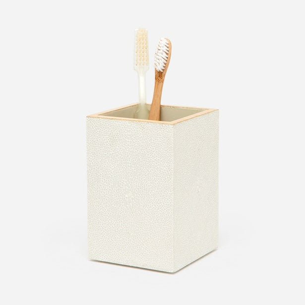 Ivory shagreen-embossed brush holder with gold rim, holding two toothbrushes.