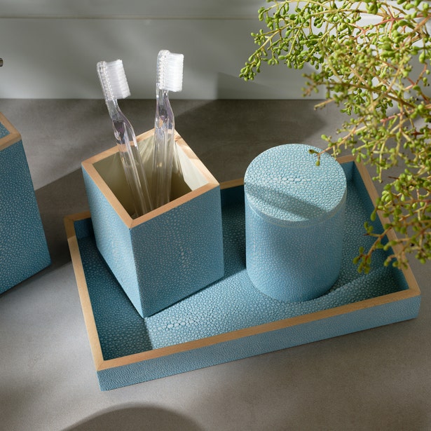 Teal shagreen-textured bath canister with gold trim, styled on matching tray with toothbrush holder.