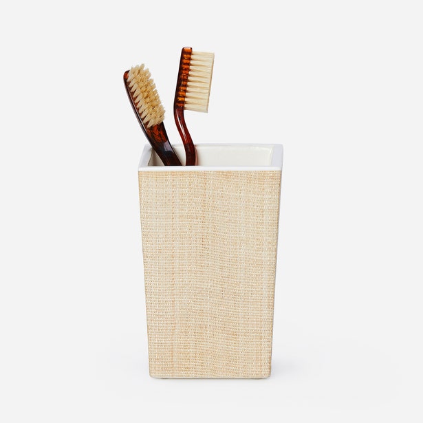Pigeon & Poodle Maranello brush holder in natural raffia with two toothbrushes.
