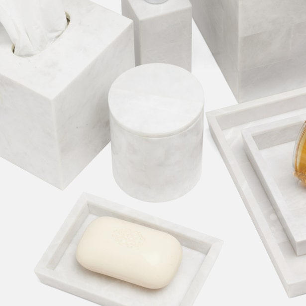 White marble Milan bath canister among matching accessories including soap dish, tray, and tissue box.