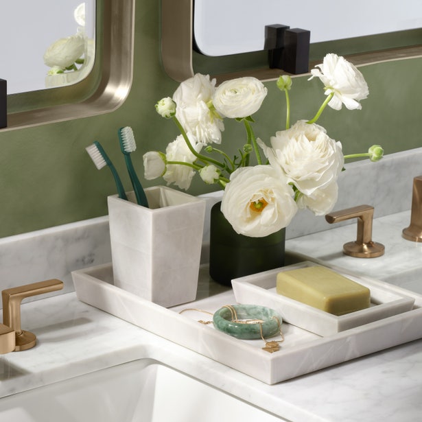 Marble-look Milan bath canister with toothbrushes, styled on vanity tray with florals and soap.