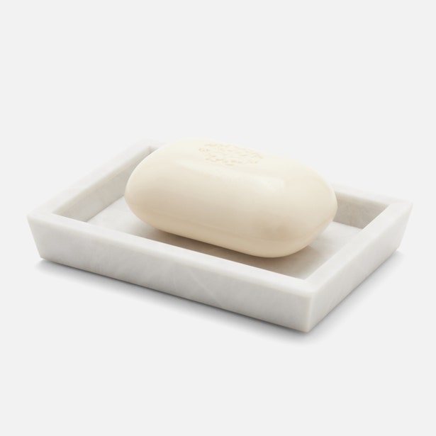 Pigeon & Poodle Milan white marble soap dish holding an ivory bar of soap.