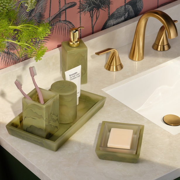 Sage green onyx-style bathroom set with soap pump, toothbrush holder, tray, and dish on marble vanity.