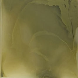 Close-up of olive green soap pump base with subtle light reflections.