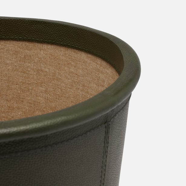 Close-up of olive leather rim and camel linen interior of Ogden wastebasket.