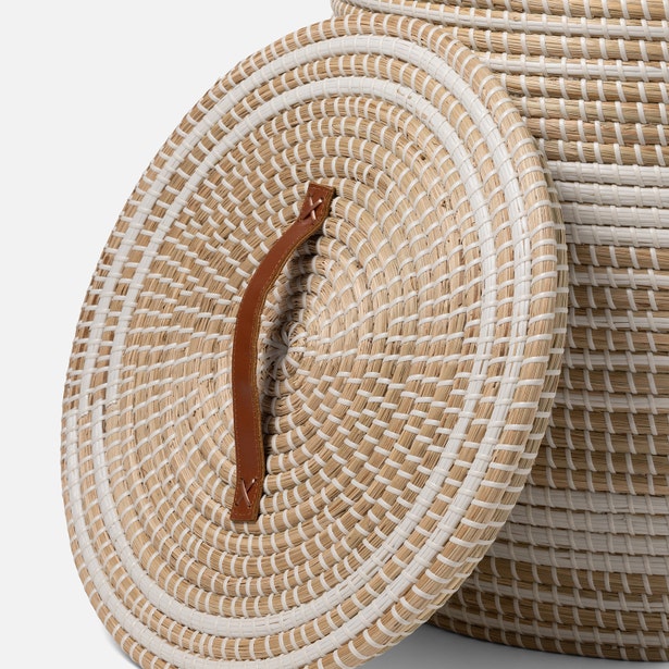 Close-up of Olinda hamper lid with spiral seagrass weave and tan leather handle.