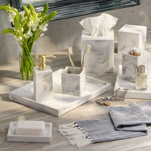 Pigeon & Poodle Parma soap dish in white marble resin beside a fringed gray hand towel.
