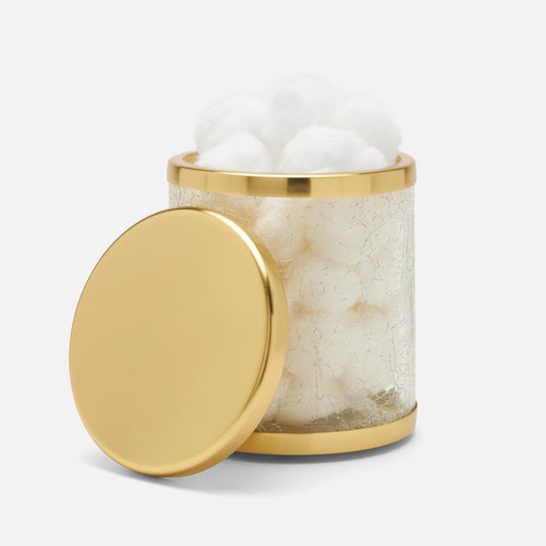 Pigeon & Poodle Pomaria bath canister open with gold lid resting against side, filled with cotton balls.