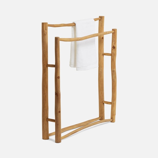 Pigeon & Poodle Provo teak towel rack with white towels draped over natural wood bars.