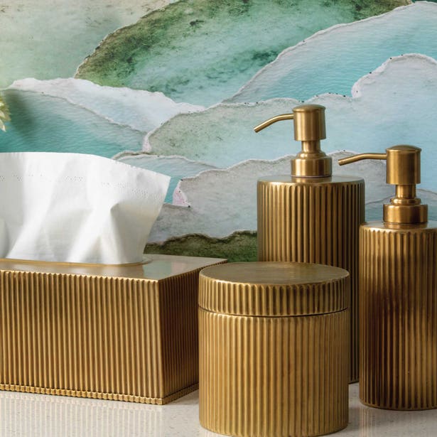 Pigeon & Poodle Redon gold reeded bath accessories set styled against watercolor wall art.
