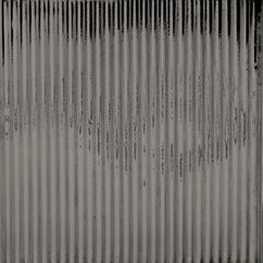 Close-up of ribbed glass texture on Redon bath canister in charcoal tones.
