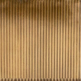 Close-up of ribbed gold-toned surface texture on Redon bath canister.