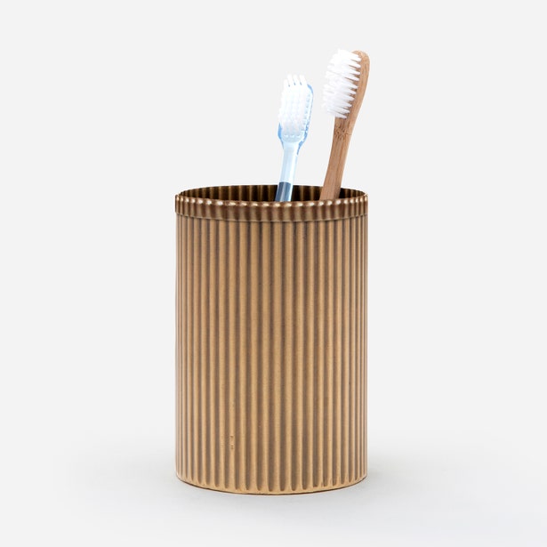 Pigeon & Poodle Redon brush holder in brass with vertical ribbing, holding two toothbrushes.
