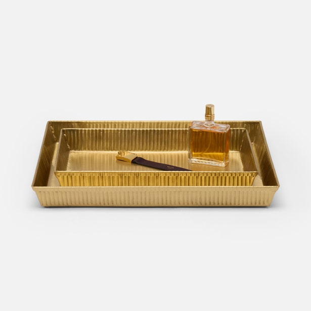 Pigeon & Poodle Redon gold ribbed nesting tray styled with perfume bottle and nail file.