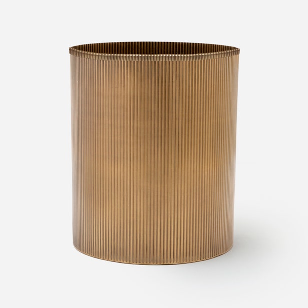 Pigeon & Poodle Redon wastebasket in antique brass with vertical ribbed texture.