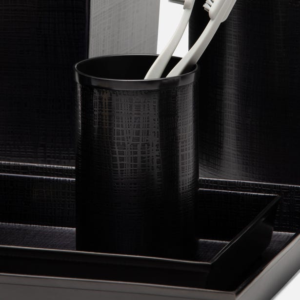 Black crocodile-embossed bath canister holding toothbrushes, styled on matching tray.