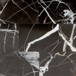 Close-up of black marble texture with white veining on Rhodes bath canister surface.