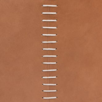 Close-up of tan leather with white whipstitch seam detail on Pigeon & Poodle Salo basket.
