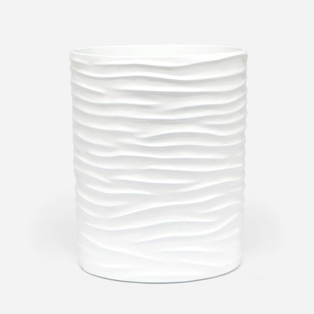 Pigeon & Poodle Solin wastebasket in white with horizontal wave-textured relief.