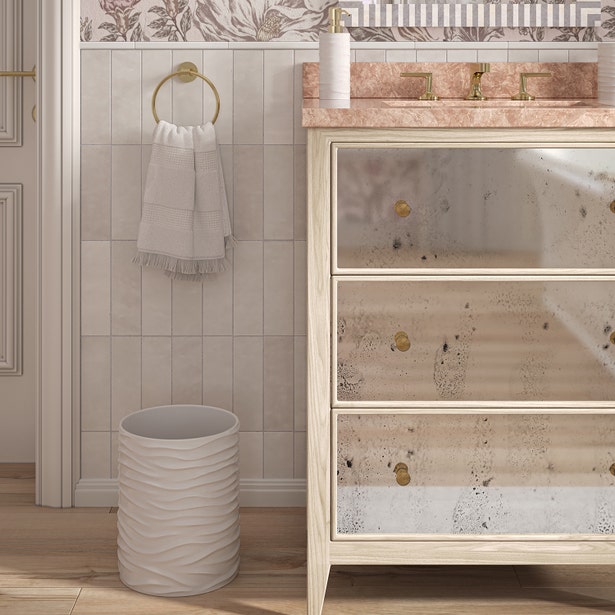 Pigeon & Poodle Solin wastebasket in white with wave-textured exterior, styled in elegant bathroom.