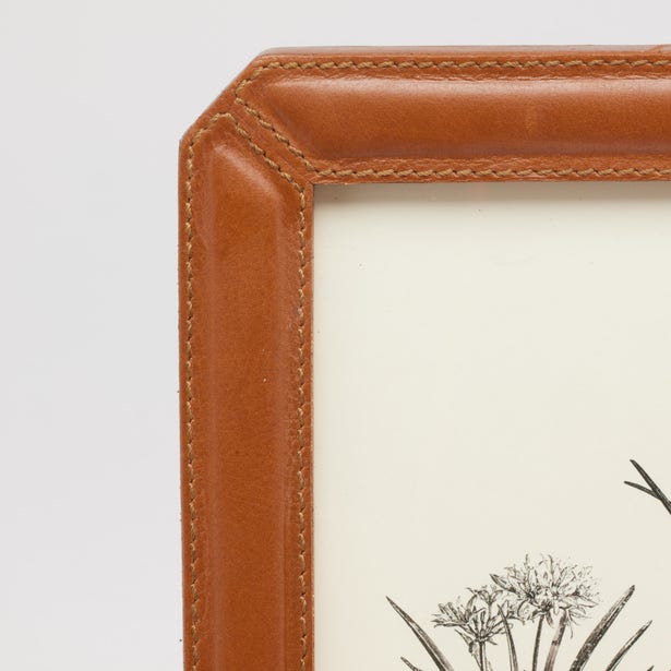 Close-up of Pigeon & Poodle Stanley frame corner in tan leather with contrast stitching detail.