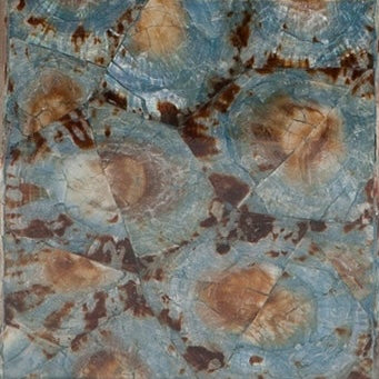 Close-up of Pigeon & Poodle Sitges bath canister surface in blue and amber fossil stone pattern.
