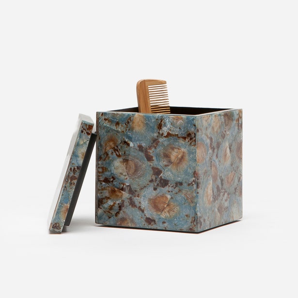 Pigeon & Poodle Sitges bath canister in blue fossil stone with lid ajar and wooden comb.