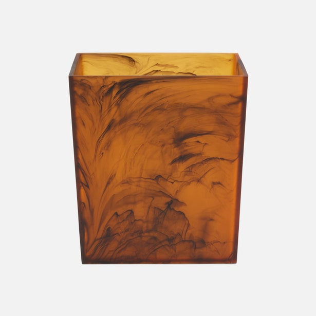Pigeon & Poodle Tavira wastebasket in amber tortoise resin, angled front view.